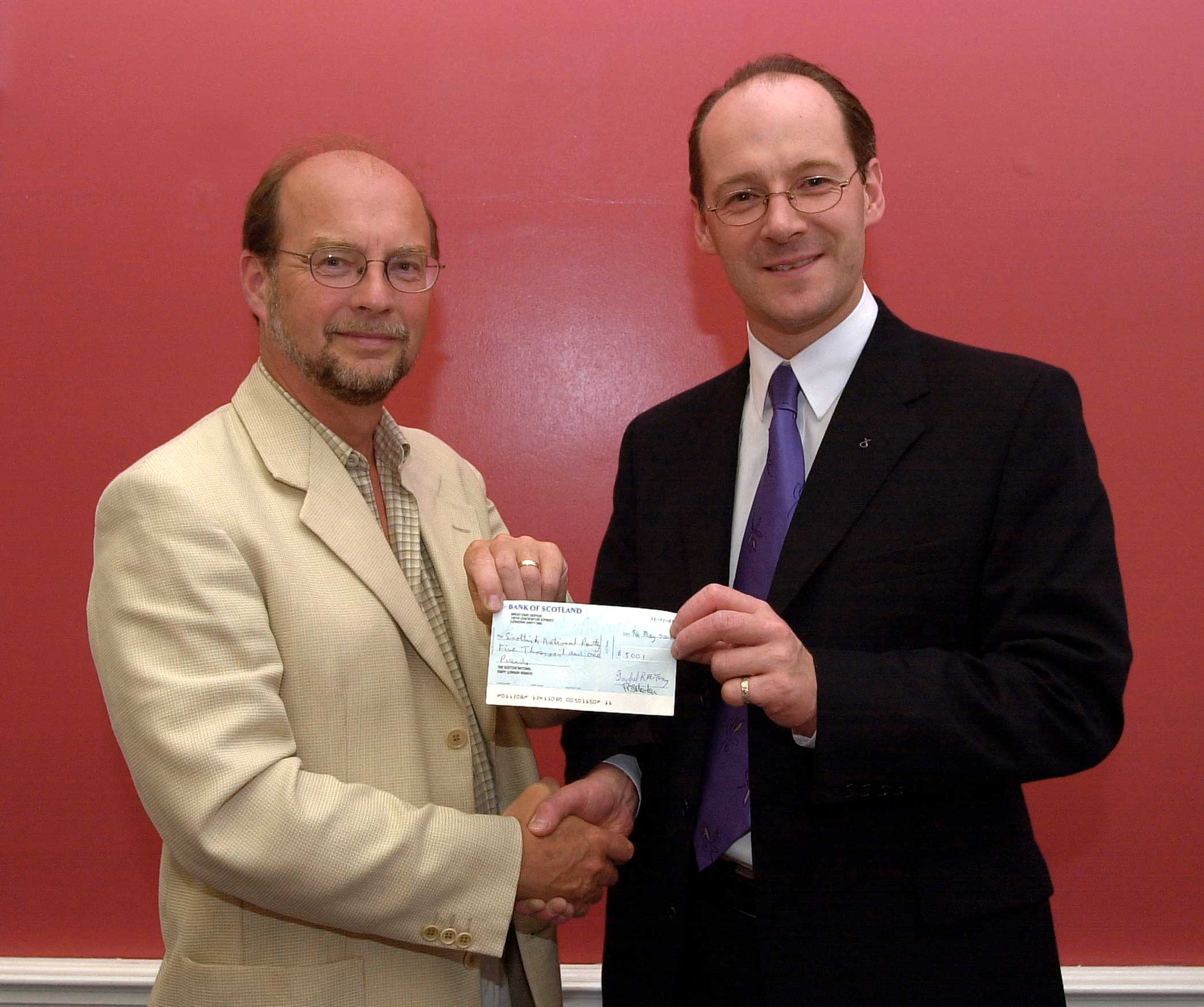 John Green presenting a cheque to John Swinney